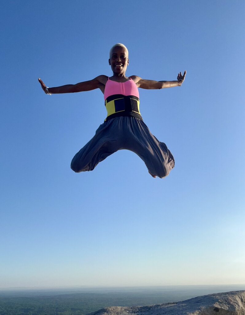 Jumping high on the top of Stone Mountain Georgia.